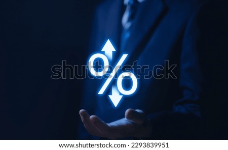 Businessman hand showing percentage icon and up or down arrow Business concept, finance, economy, mortgage, bank interest rate, loan, investment, stock growth and dividends.