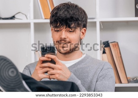 student looking at mobile phone or smartphone