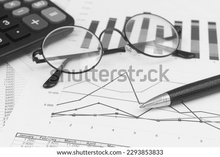 Market statistics, calculator, eyeglasses and pen close-up. Business concept.