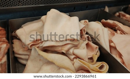 Pork skin is mineralized into a thin sheet without fat sticking through cleaning until the pig skin has a white skin. Royalty-Free Stock Photo #2293866961