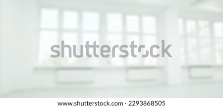 Empty room with white wall and large windows, blurred view. Banner design