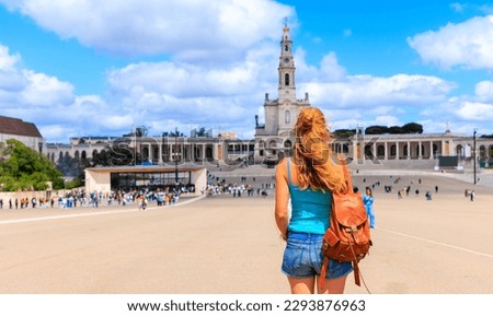 Mary basilica of Lady of Rosary Fatima in Portugal- Rear view of woman looking at cathedral Royalty-Free Stock Photo #2293876963