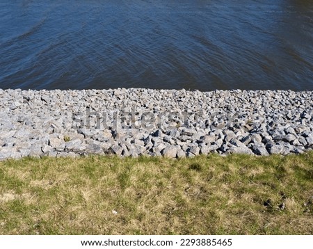 Fortified embankment of the river. Flood protection. Royalty-Free Stock Photo #2293885465