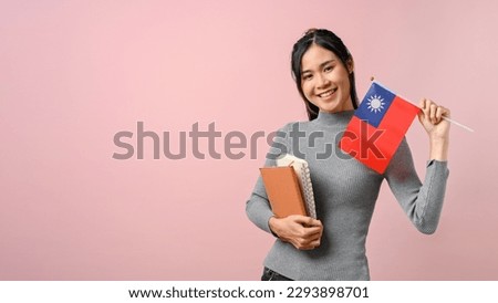 Beautiful Asian girl showing Taiwan flag on pink isolated background, education concept. study abroad concept.