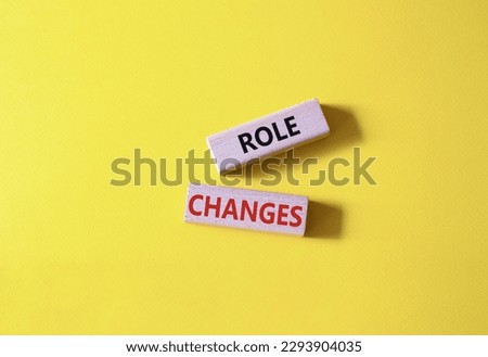 Role changes symbol. Concept words Role changes on wooden blocks. Beautiful yellow background. Business and Role changes concept. Copy space.