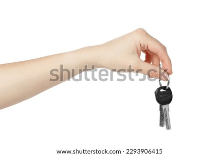 Hand holding keys to apartment on white background. Royalty-Free Stock Photo #2293906415