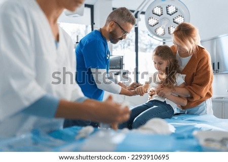 Little girl with her mother in surgery examination. Royalty-Free Stock Photo #2293910695