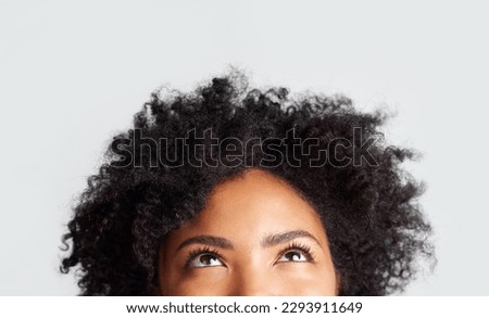 Woman, eyes looking up and cropped in studio with thinking, ideas and hope by gray background. Young female model, african girl and think for mindset with afro, vision and daydream by backdrop Royalty-Free Stock Photo #2293911649