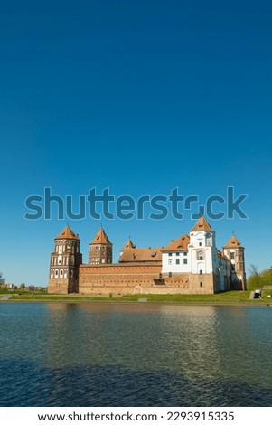 Castle complex on the lake shore against the blue sky