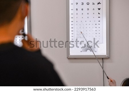 Looking at an Korean eyesight test chart. Royalty-Free Stock Photo #2293917563