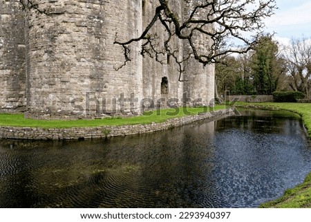 Nunney Castle and moat in the village of Nunney. Built in the 1370s by Sir John de la Mere, Somerset, England, United Kingdom - 8th of April 2023 Royalty-Free Stock Photo #2293940397