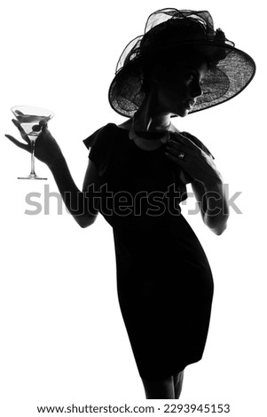 Nothing says class like a martini glass. Studio shot of a stylish woman in silhouette drinking a martini against a white background.