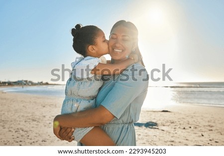 Mommy, I love you. Shot of a little girl giving her mother a kiss on the cheek at the beach.