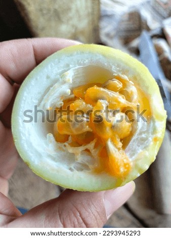 A picture of passion fruit that classified as genus Passiflora, Passion fruit are found or oval , The fruit can be yellow, red, purple, and green, The fruit have a juicy edible center composed of seed