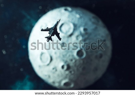Toy plane flies near the moon, starry background. The concept of space tourism development.