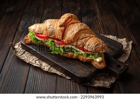 Sandwich with vegetables, meat and herbs on brown boards. Bakery products. Fresh bakery. Royalty-Free Stock Photo #2293963993