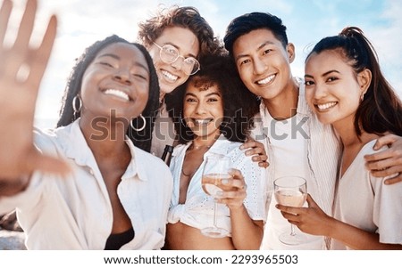 Portrait of a happy group of friends talking a selfie while at the beach. 
