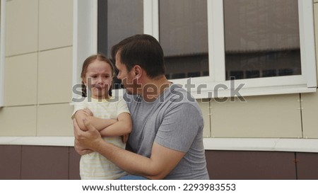 little girl makes scandal her dad. Upset Child throws temper tantrum father. happy family. emotional stress Child outdoors. Child cries throws tantrum his father. crying kid. little daughter parent . Royalty-Free Stock Photo #2293983553