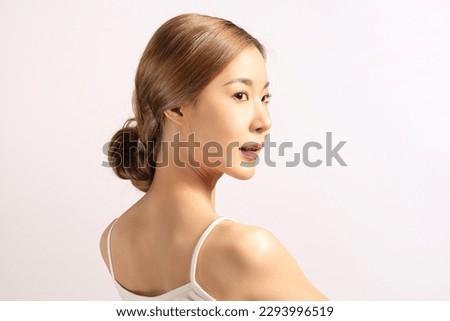 The beautiful Asian woman showing clear skin on the white background. Royalty-Free Stock Photo #2293996519
