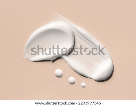 cosmetic smears of creamy texture on a beige background Royalty-Free Stock Photo #2293997345