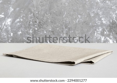 top view with gray kitchen napkin isolated on table background. Folded cloth for mockup with copy space, Flat lay. Minimal style. Royalty-Free Stock Photo #2294001277