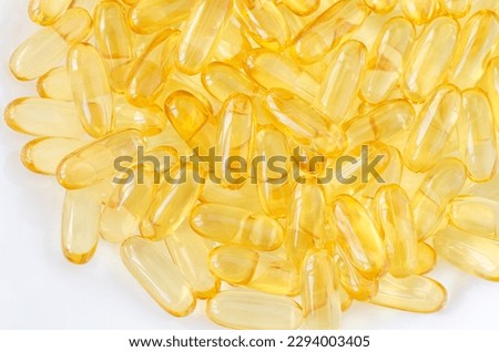 Cod-liver oil (vitamin D, E, A, cosmetic serum) supplement softgel capsules. Close-up, selective focus Royalty-Free Stock Photo #2294003405