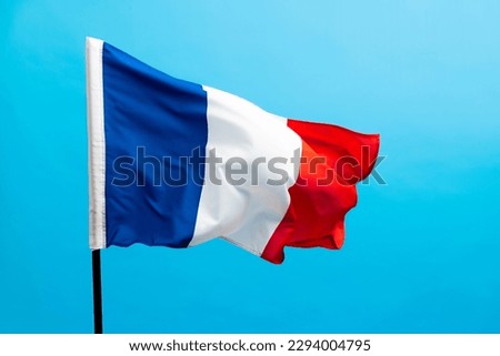 French flag waving on blue background.