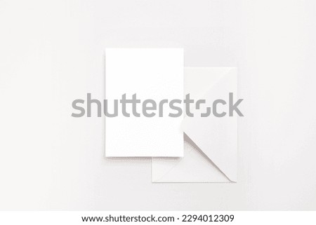 Minimalist 5x7 card with white envelope on white background