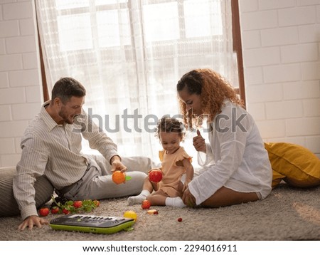 Parents teach children how to walk, hold objects, take turns, play symbolic toys, and express emotions. Love, direction, inspiration, and protection are given. Character and personality development. Royalty-Free Stock Photo #2294016911