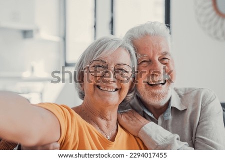Head shot portrait happy senior couple taking selfie, having fun with phone cam, smiling aged wife and husband hugging, looking at camera, posing for photo, aged man vlogger recording video Royalty-Free Stock Photo #2294017455