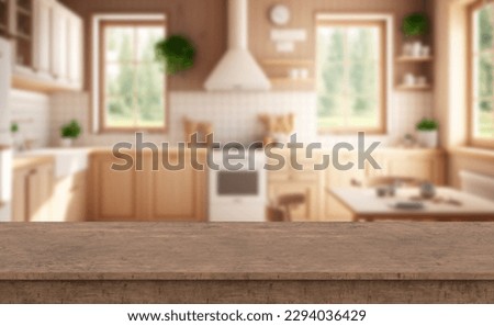 Close up photo of contemporary kitchen island with oak wood table top with kitchen blurry loose focal background