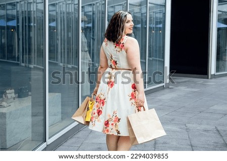 How to Shop for Summer Fashion on a Budget. Choosing the Right Fabrics for Hot and Humid Summer Weather. Outdoor portrait of stylish curvy woman with shopping bags Royalty-Free Stock Photo #2294039855