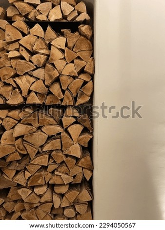 Having a tightly stacked pile of firewood as an interior design element on a beautiful wall.