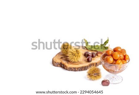 Chestnut dessert and chestnuts on a plate. Traditional delicious Turkish dessert; chestnut candies (Kestane Sekeri) Royalty-Free Stock Photo #2294054645