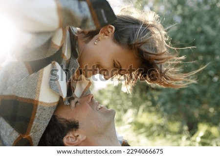 Close up portrait man and woman laughing together.Romantic affectionate couple on a holiday.Couple embracing and smiling. Sunset sunshine .