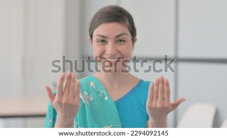 Portrait of Indian Woman in Sari Inviting People