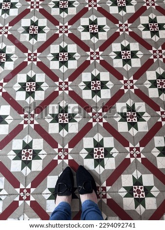 foot on Heritage tiles floral pattern of Penang old building. floor tiles wallpaper concept. selective focus image