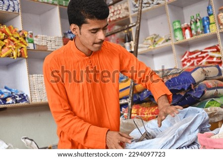 Portrait of an Indian man in his shop.