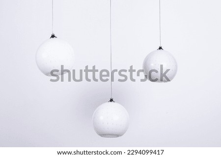 Modern Vintage Retro different models Silver bronze chandeliers hanging on white backdrop macro Detail shot interior decoration decorative electrical electronic lighting Industrial abstract pastel bac