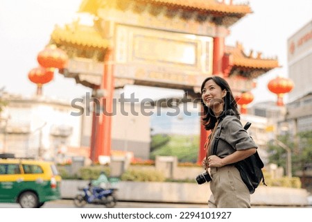 Young Asian woman backpack traveler enjoying China town in Bangkok, Thailand. Journey trip lifestyle, world travel explorer or Asia summer tourism concept. Royalty-Free Stock Photo #2294101927