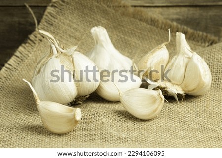 Fresh garlic close-up, garlic cloves on a wooden background. Space for text