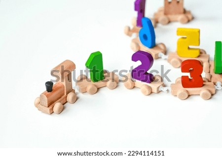 Wooden train with numbers on a white isolated background. Children's educational logic toys are used in Montessori games for development.