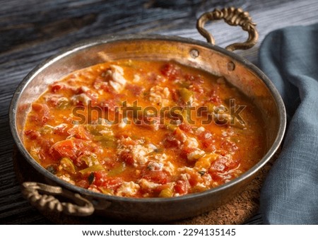 Famous Turkish menemen dinner on table, made by eggs, pepper and tomatoes. Royalty-Free Stock Photo #2294135145