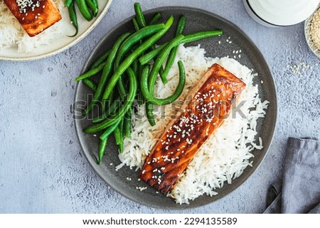 Honey teriyaki salmon with green beans and rice, top view. Asian cuisine recipe. Royalty-Free Stock Photo #2294135589