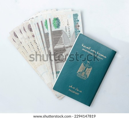 Egyptian Passport, Isolated on White Background, Arabic Text "Arab Republic of Egypt Passport" with Egpytian banknotes Royalty-Free Stock Photo #2294147819