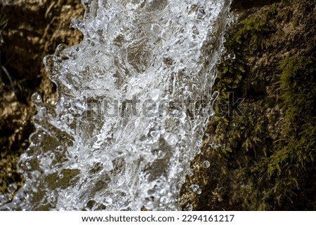 Water splashes in the air on a dark background. Shallow depth of field