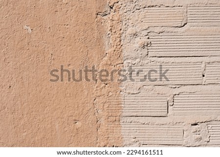 A cheap brick wall painted in a light color next to a smooth one in a slightly darker color