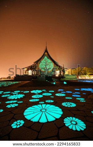 Beautiful architecture of Church temple with bodhi tree glowing and fluorescence lotus painting on the floor at Wat Sirindhorn Wararam or Wat Phu Prao at Ubon Ratchathani, Thailand Royalty-Free Stock Photo #2294165833