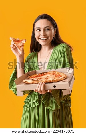 Young woman in dress with box of tasty pizza on yellow background Royalty-Free Stock Photo #2294173071