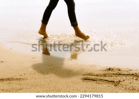 Walking on the beach. Beautiful set of colours and shadows to create this picture.